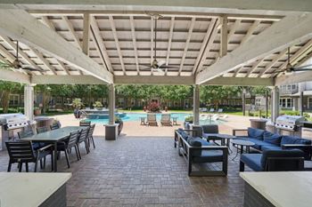 Covered outdoor pavilion with grills and pool area